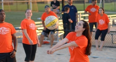 team playing sand volleyball